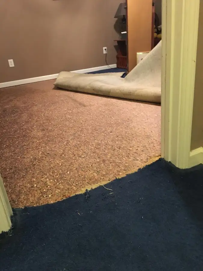Carpet pad removal revealing water damage during Drying & Dehumidification in Chamblee